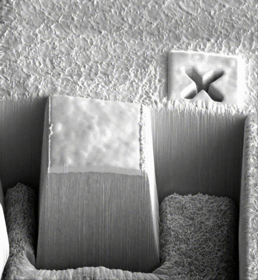 **Black-and-white interior with geometric blocks and a small X on a panel.**